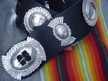 Sterling silver conchos and buckle are mounted on a 3" wide leather belt. Leroy hammers, stamps, and solders each piece into the shape he wants. 