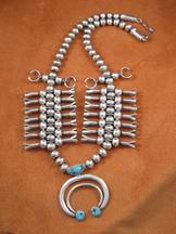 An award winning design, this necklace is unique with it's double squash blossoms. 3 turquoise on the naja.